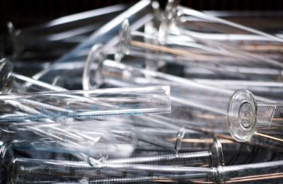 A loose pile of clear glass laboratory pipettes.